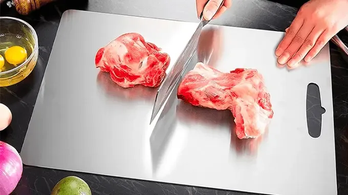 Chef knife slicing effortlessly on titanium